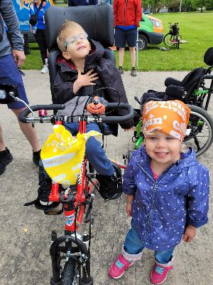 From our 2024 CRF walk - Conor in his bike and Lyla happy to participate